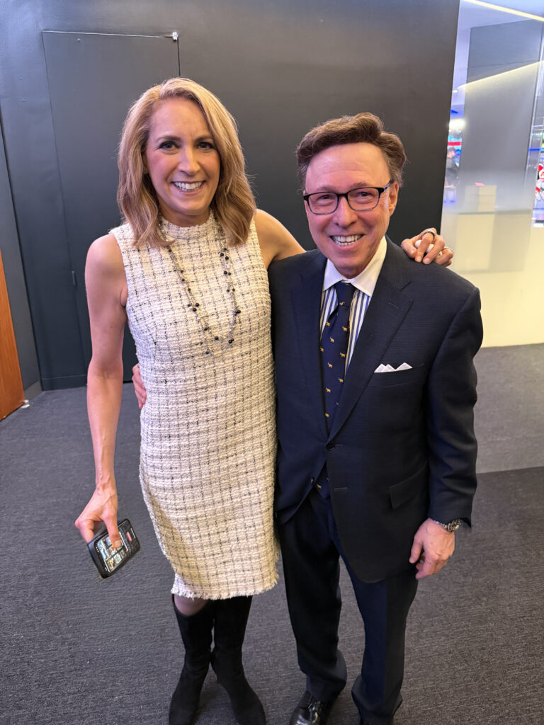 Derek Bryson Park alongside the CEO of Metropolitan Capital Advisors, Karen Lisa Finerman, at Nasdaq MarketSite in Times Square, New York